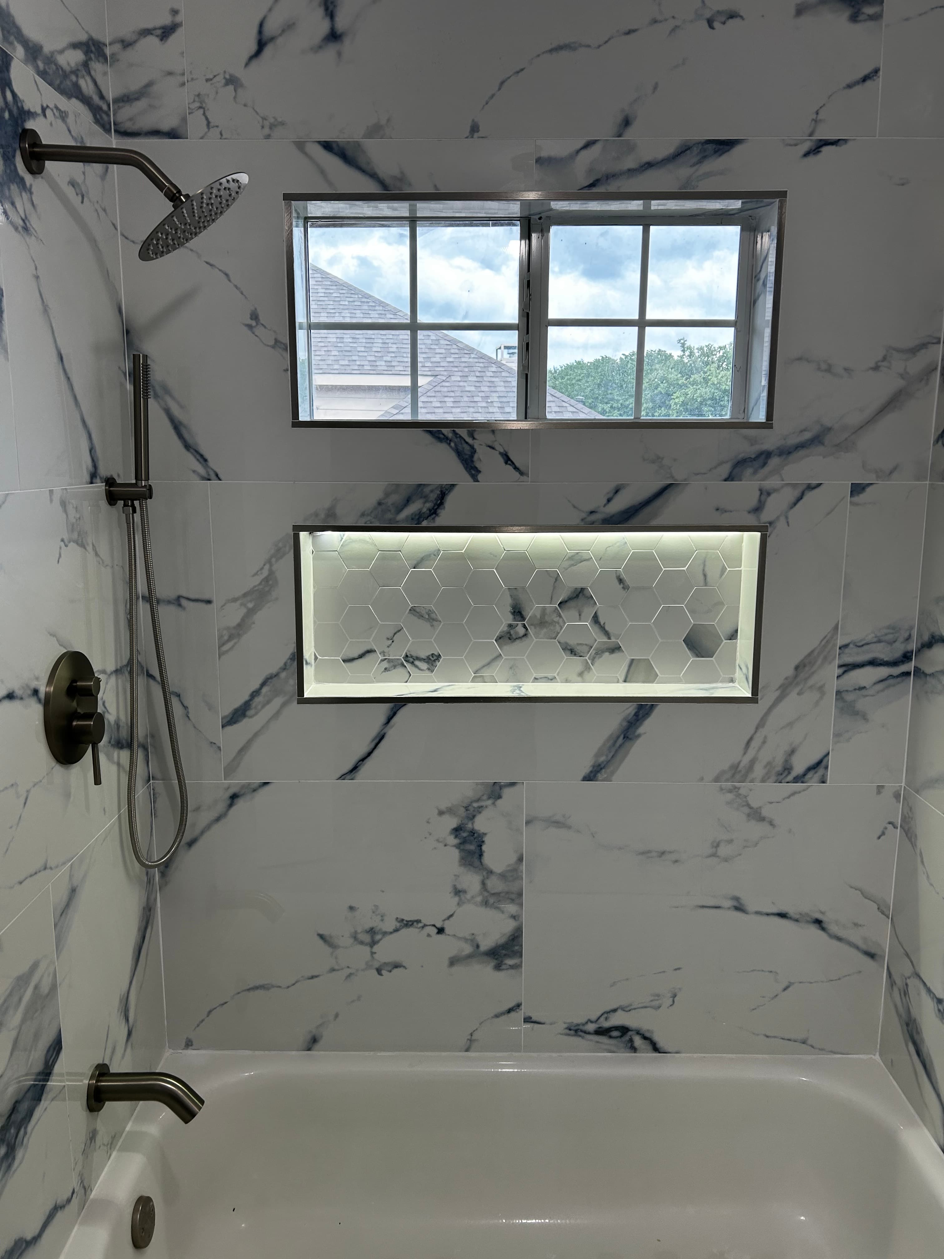 Remodeled Austin bathroom with a tiled walk-in shower by HN Construction & Remodeling